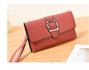 Macro detail of red lychee grain leather handbag with silver square buckle and wristlet