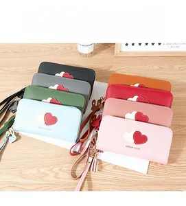 Showcase of colorful long PU leather wallets featuring heart patterns and tassel charms