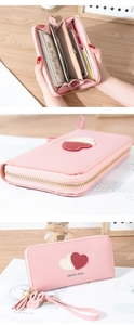 Detail of pink long heart wallet interior showing multiple card slots and phone compartment
