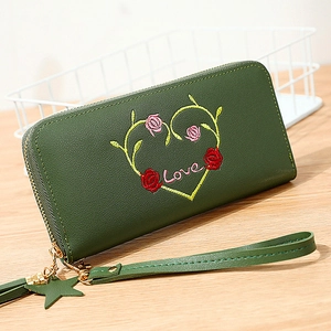 Long zip-around green faux leather wallet with heart embroidery and wrist strap