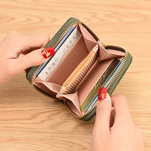 Dark green leather wallet for women with pink interior card slots and zipper pocket