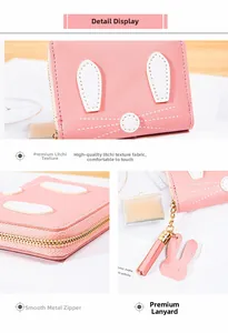 Detail display of pink rabbit coin purse with smooth metal zipper and tassel charm