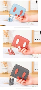 Detailed close-up of cute rabbit style mini wallets with tassels in three soft colors