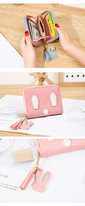 Detail of pink rabbit mini wallet interior with card slots, coin pocket and tassel