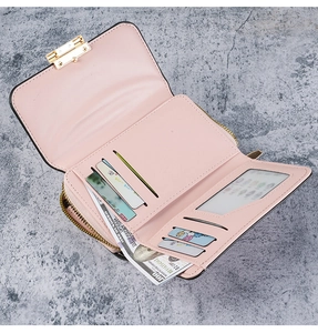 Close-up of pink leather wallet showing multiple card slots and large bill compartment