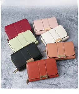 Close-up of compact multi-color women's wallets with gold zippers and metal buckles