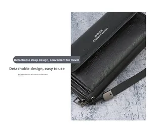Detail of men's leather clutch showing the detachable wrist strap and metal zipper