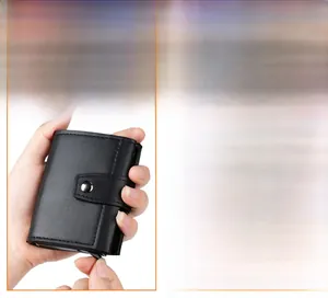 Detail of black pebbled leather tri-fold wallet showing the automatic pop-up card mechanism