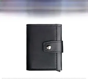 Close-up of black textured leather wallet featuring silver metal snap button closure