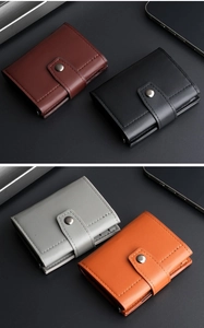 Close-up of leather tri-fold wallets in brown, black, grey and orange with metal snaps