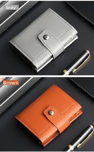 Detailed view of grey and brown leather wallets with snap buttons and stitching