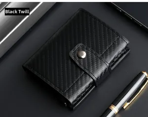 Close-up of black carbon fiber texture wallet with button and business accessories