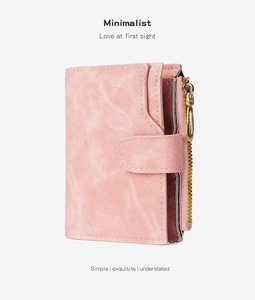 Detail showing pink matte PU leather texture and fine stitching on a small wallet