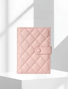 Macro shot of pink quilted faux leather passport wallet with snap button closure