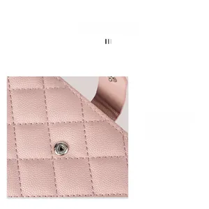 Detail of pink quilted passport holder featuring silver alloy button and neat stitching