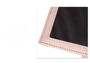 Detail view of pink pebbled leather edges and precise black fabric lining with stitching