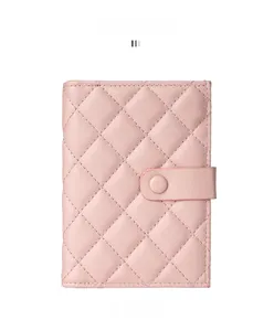 Detailed macro view of pink quilted leather passport wallet and card holder
