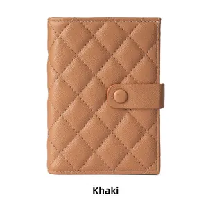 Close-up of khaki quilted leather travel wallet with rhombus pattern and snap button