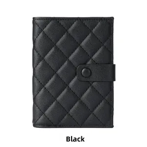 Detail of black caviar leather passport holder with classic diamond quilted pattern