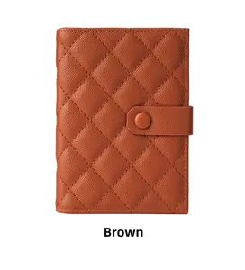 Close-up of brown caviar leather passport holder with quilted pattern and snap closure