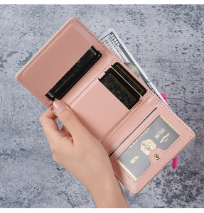 Detail of pink faux leather wallet featuring multiple card slots and clear ID window