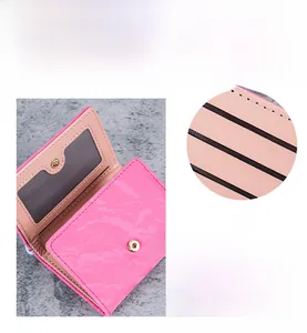 Pink PU leather wallet detail showing multiple card slots and secure metal snap closure