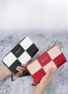 Close-up of checkered long wallet featuring lychee grain texture and wrist strap zipper
