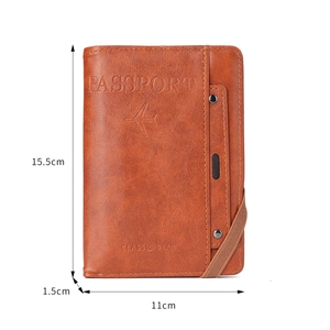 Brown leather passport holder with elastic closure, measures 15.5cm x 11cm x 1.5cm