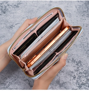 Macro view of blue long wallet interior showing card slots and large phone compartment