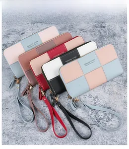 Detail view of colorful patchwork long wallets with lychee texture and wrist strap