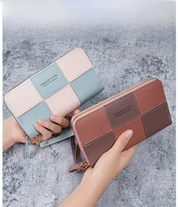 Detail of checkered patchwork long wallets with gold zippers and wrist straps