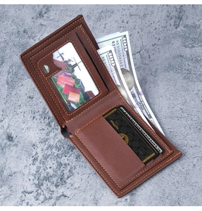 Detail view of deep brown bifold PU leather wallet with orange stitching and money slots