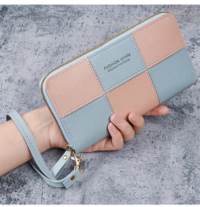 Detail view of pink and blue checkered long wallet with textured finish and wrist strap