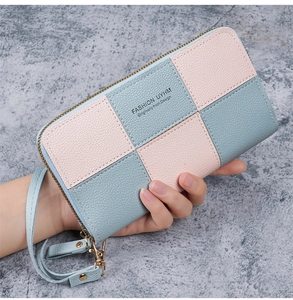 Detail of pink and blue checkered long wallet with zipper and wrist strap