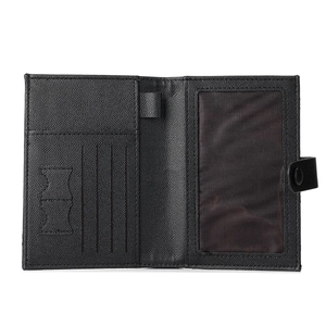 Minimalist black pebble leather travel wallet with passport holder and pen loop feature