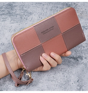 Detail of multi-color patchwork long wallet in lychee grain leather with wrist strap
