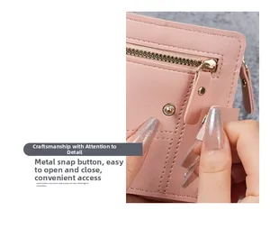 Detailed view of pink leather wallet featuring durable metal snap button and zipper pocket