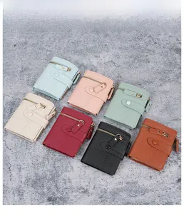 Flat lay of multiple color women short wallets with pebbled faux leather and zip closure