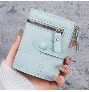 Detail of light blue lychee texture wallet with gold zipper and coin pocket