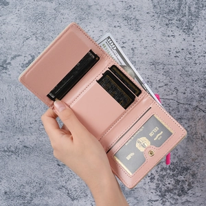 Pink minimalist tri-fold women's wallet featuring multiple card slots and clear ID window
