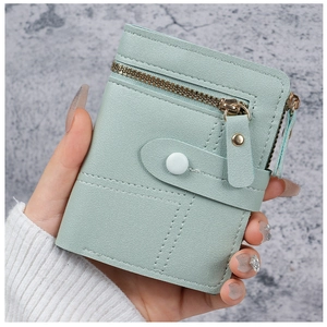 Detail of mint green pebble leather wallet showing zipper pocket and snap closure