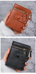 Detail of brown and black leather wallets with double zipper and buckle closure
