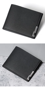 Detail of black bifold leather wallet featuring lychee texture and silver metal trim