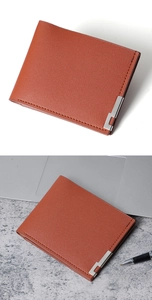 Close-up of brown leather men's wallet with lychee grain and silver metal corner detail
