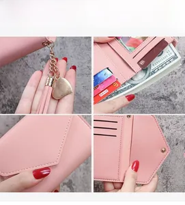 Dettaglio del portafoglio rosa in ecopelle con nappa a cuore e interno con scomparti multipli