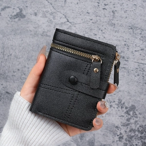 Black pebbled faux leather wallet with dual zipper and button detail held by a model