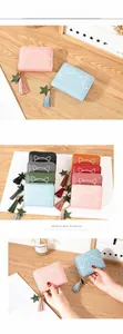Detail of cute cat print on PU leather wallet with zipper tassel and star charm