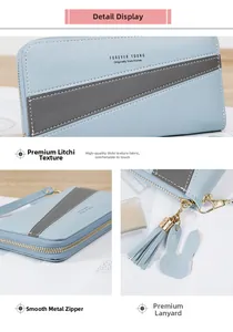 Detail of light blue lychee pattern faux leather wallet with gold zipper and rabbit charm