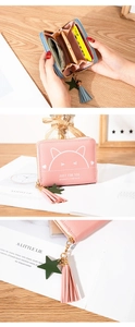 Detailed interior of a cat print wallet with organ-style card slots and tassel zipper