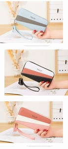 Close-up of color-block long zip wallets for women with tassels and wristlet straps